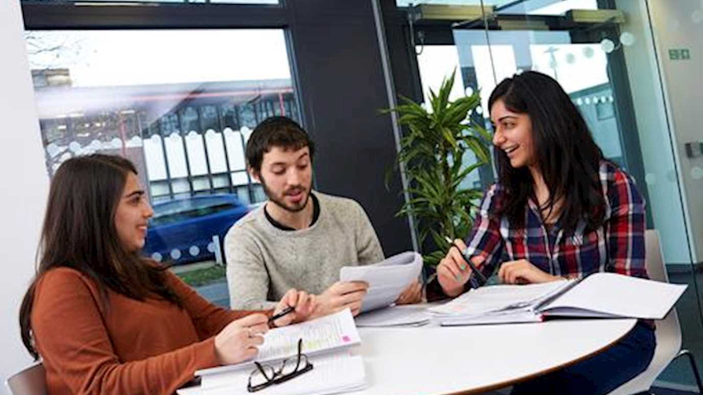 students round  a table studying - mature students